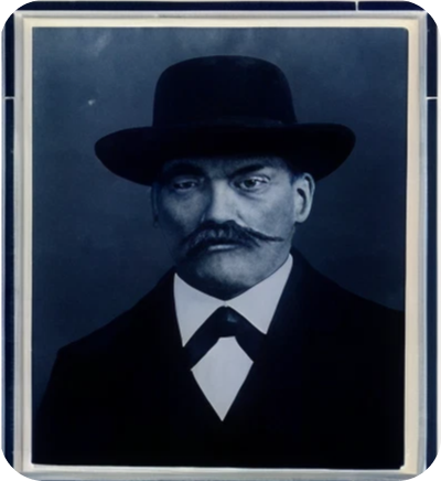 Formal vintage portrait of mustached man wearing hat