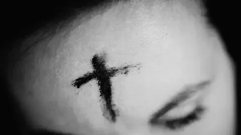 Close-up of ash cross on forehead