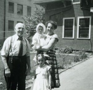 Vintage three-generation family portrait outdoors