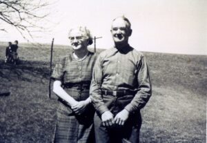 Vintage photo of elderly couple standing outdoors