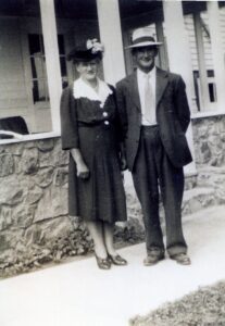 Vintage couple standing by stone porch