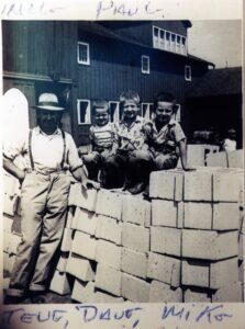 Man and three boys on stacked concrete blocks