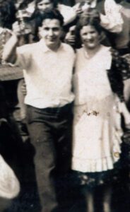Vintage couple celebrating, man raising glass