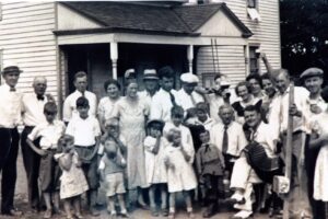 Historical family reunion on farmhouse porch