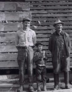 Two men and a boy in vintage workwear
