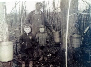 Vintage family collecting maple sap