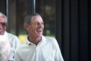 Smiling elderly man in white polo shirt