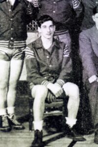Seated vintage athlete in striped uniform