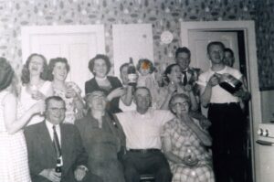 Vintage black-and-white group celebrating with drinks