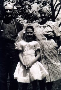 Young girl in veil between elderly couple