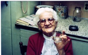 Smiling elderly woman holding a drinking glass