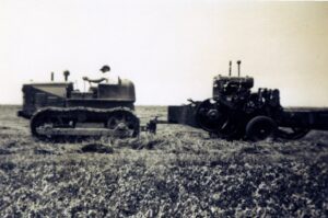 Antique tracked tractor pulling farm engine