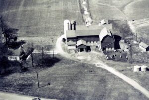 Aerial view of farm with barn and silos