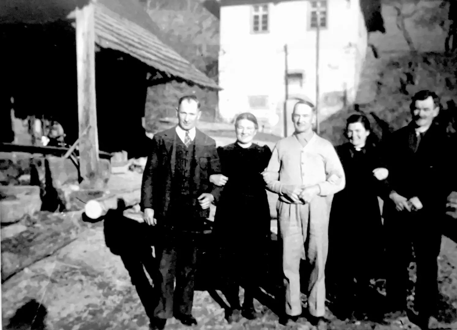 Vintage family of five outside old farmhouse