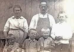 Sepia portrait of family with three children