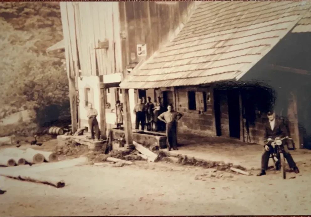 Vintage sawmill with workers and motorcycle